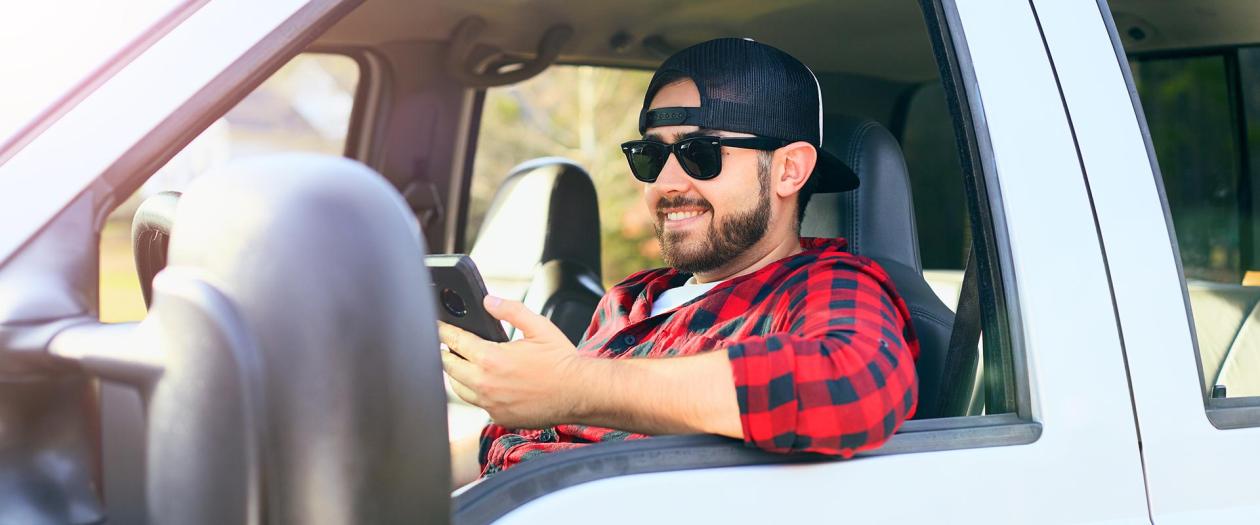 smiling man driving new truck